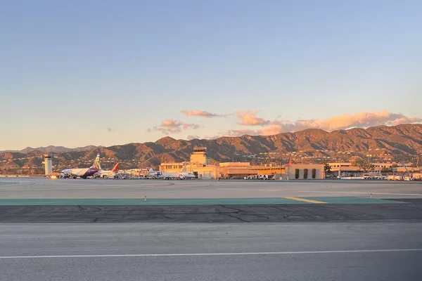 Hollywood Burbank Airport's terminal and runway below the Verdugo Mountains